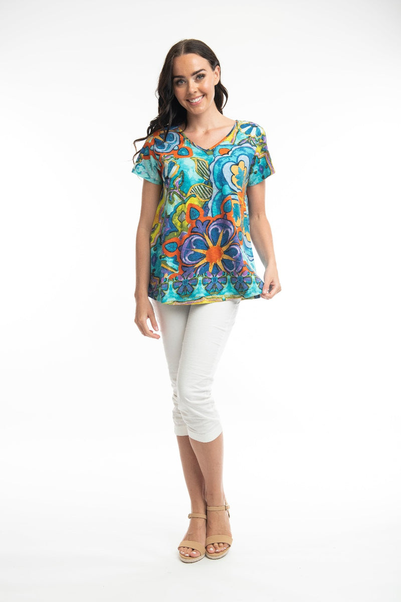 The printed t-shirt is a long line, contemporary, a-line  loose fit. It is short sleeved with a v-neck. 