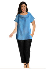 The Atri linen top has a boat neck, cap sleeves & curved, long line back hemline.