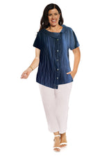 The Como shell top is made in crinkle linen with a cap sleeve. the collar is off centre as are the the front non functioning button. The hem line is longer on one side . The length of the top is to the hip.