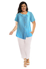 The Como shell top is made in crinkle linen with a cap sleeve. the collar is off centre as are the the front non functioning button. The hem line is longer on one side . The length of the top is to the hip.