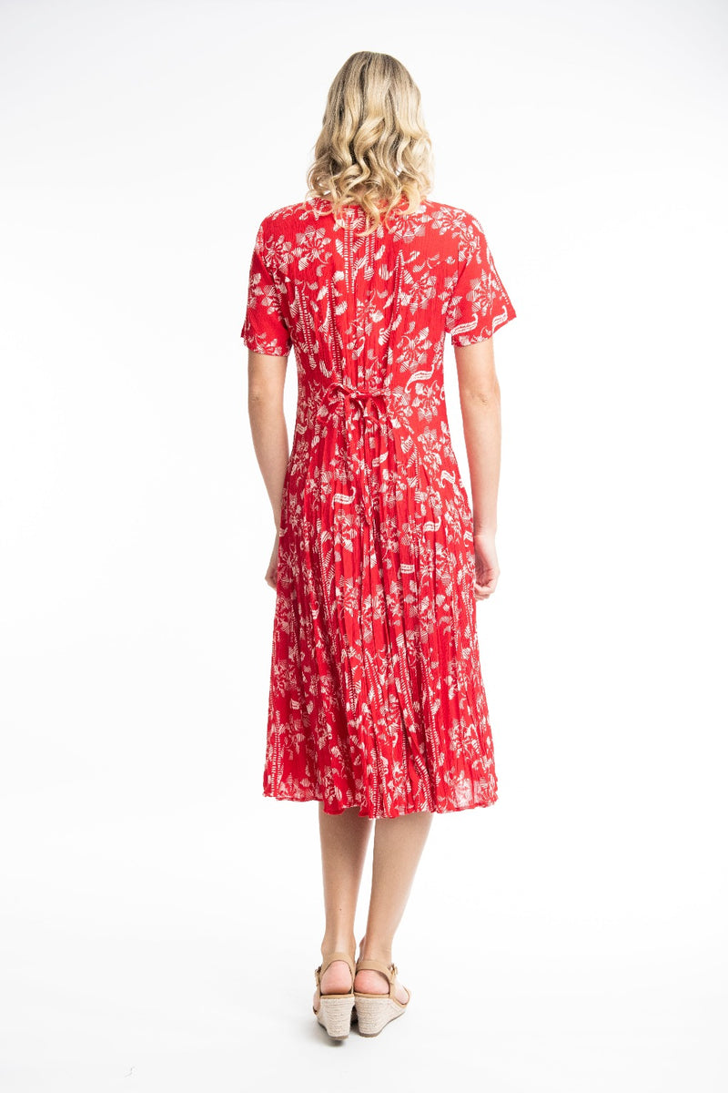 The Giza Godet Dress from Orientique has a v-neckline & short sleeves. It has godets to add fullness to the skirt & is a flattering calf length. It has a string tie & looks which can be tied at the back or at the front.