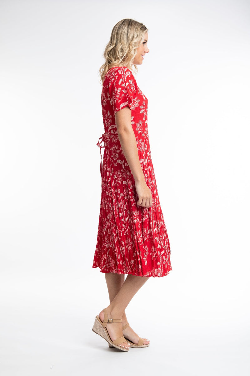 The Giza Godet Dress from Orientique has a v-neckline & short sleeves. It has godets to add fullness to the skirt & is a flattering calf length. It has a string tie & looks which can be tied at the back or at the front.