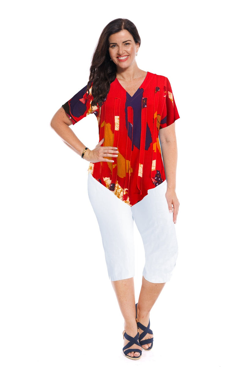 This Bali top has sewn on printed fabric panels on the front & a plain printed back & peaked hemline.