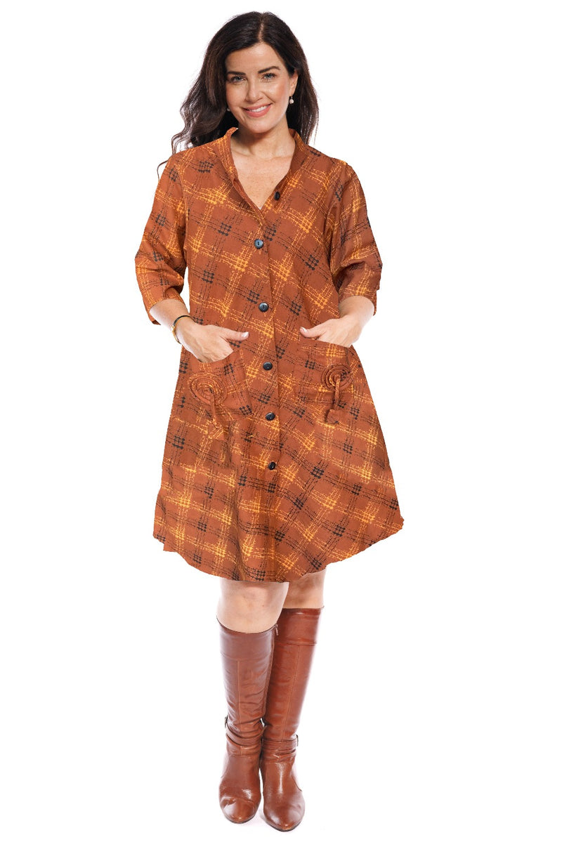 The Japanese coat frock dress has an a-line shape & over the elbow length sleeve. The wooden buttons are a simple finish to a garment brimming with design features. The front patch pockets have a self-fabric spiral & tassel.